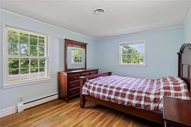 1372 Canandaigua Rd, Macedon, NY 14502 - bedroom with baseboard heating, multiple windows, ornamental molding, and wood finished floors