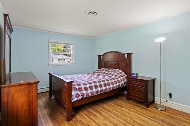 1372 Canandaigua Rd, Macedon, NY 14502 - bedroom featuring wood finished floors, baseboard heating, and crown molding