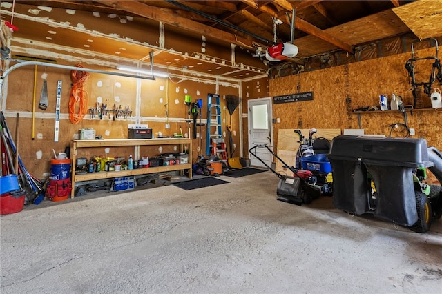 1372 Canandaigua Rd, Macedon, NY 14502 - garage with a garage door opener and a workshop area