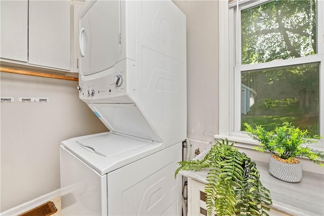 225 Dorking Rd, Brighton, NY 14610 - washroom featuring stacked washer / drying machine and cabinet space