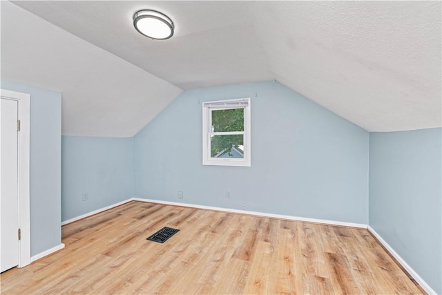 225 Dorking Rd, Brighton, NY 14610 - additional living space with wood finished floors and vaulted ceiling