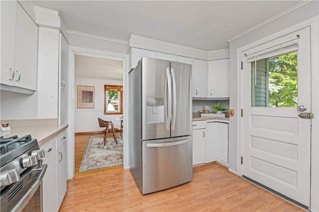 225 Dorking Rd, Brighton, NY 14610 - kitchen with stainless steel appliances, light countertops, white cabinets, plenty of natural light, and ornamental molding