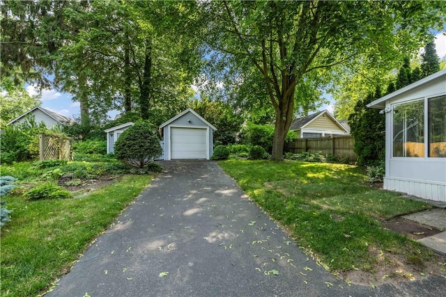 225 Dorking Rd, Brighton, NY 14610 - view of yard with asphalt driveway, an outbuilding, and a garage