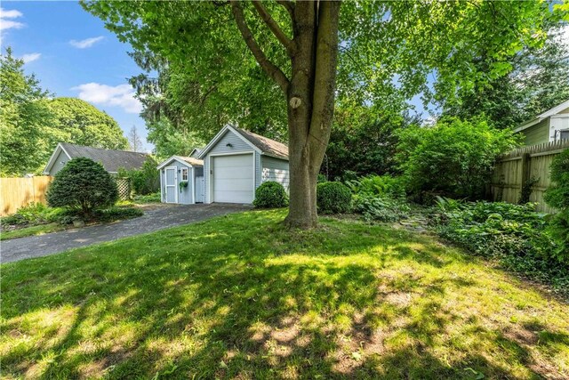225 Dorking Rd, Brighton, NY 14610 - view of yard with an outbuilding, driveway, and a detached garage
