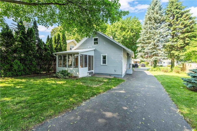 225 Dorking Rd, Brighton, NY 14610 - view of front of property with a sunroom and a front yard