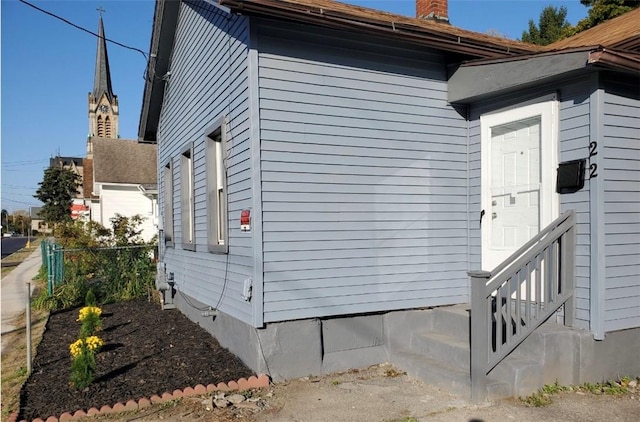22 Sullivan St, Rochester, NY 14605 - view of side of home with a chimney