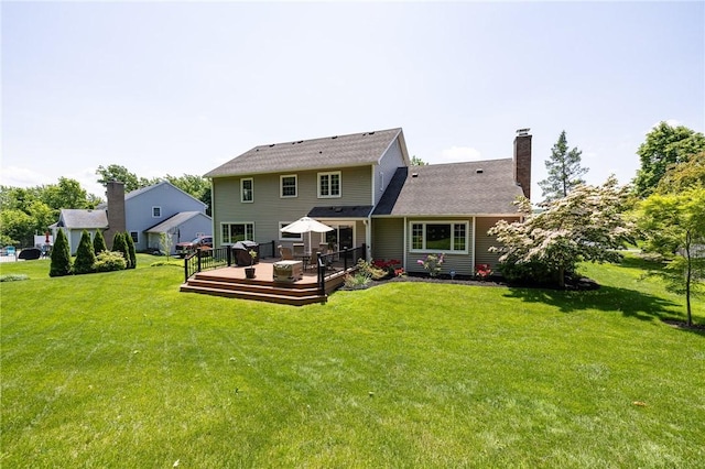 100 Broadmoor Trl, Perinton, NY 14450 - back of property featuring a deck, a lawn, and a chimney