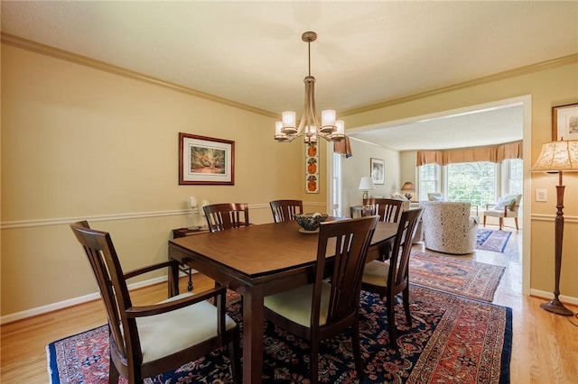 100 Broadmoor Trl, Perinton, NY 14450 - dining area featuring wood finished floors, crown molding, and a chandelier