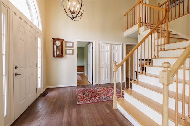 100 Broadmoor Trl, Perinton, NY 14450 - foyer entrance with a high ceiling, a chandelier, wood-type flooring, and stairway