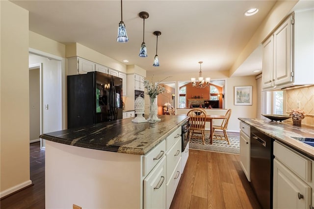 100 Broadmoor Trl, Perinton, NY 14450 - kitchen with black appliances, decorative backsplash, white cabinets, dark wood-type flooring, and decorative light fixtures