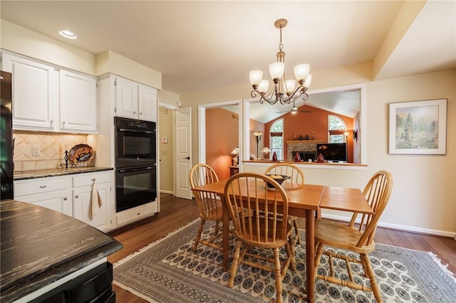 100 Broadmoor Trl, Perinton, NY 14450 - dining area with a chandelier, dark wood-style flooring, vaulted ceiling, and recessed lighting