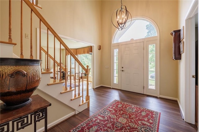100 Broadmoor Trl, Perinton, NY 14450 - entrance foyer with healthy amount of natural light, dark wood finished floors, stairway, a chandelier, and a towering ceiling