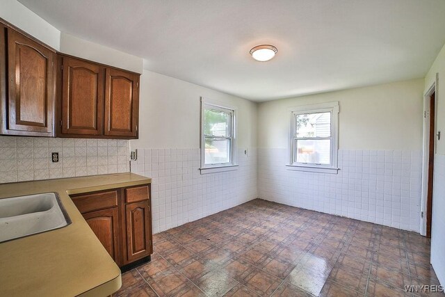 331 S Shore Blvd, Lackawanna, NY 14218 - kitchen featuring tile walls, wainscoting, and light countertops