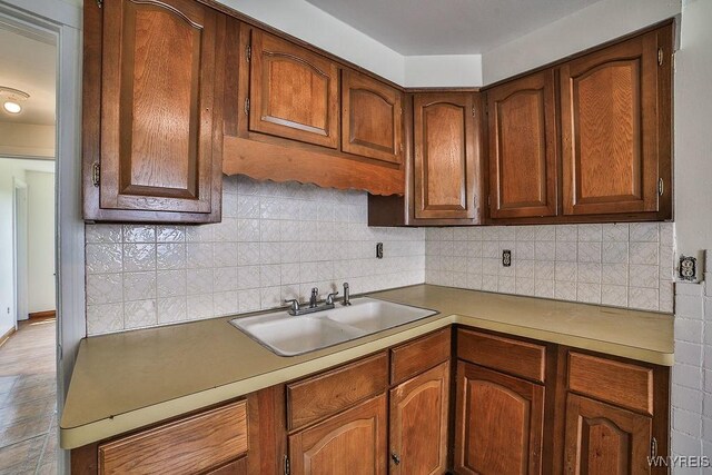 331 S Shore Blvd, Lackawanna, NY 14218 - kitchen with tasteful backsplash, brown cabinetry, and light countertops