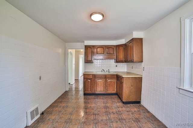331 S Shore Blvd, Lackawanna, NY 14218 - kitchen with light countertops, tile walls, and wainscoting