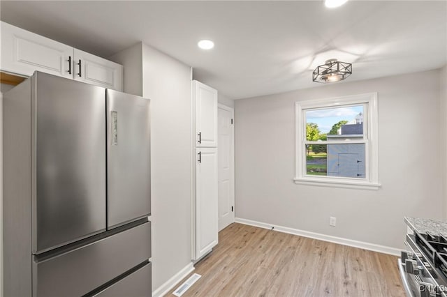 331 Darlington Rd, Syracuse, NY 13208 - kitchen with freestanding refrigerator, light wood finished floors, white cabinetry, recessed lighting, and light countertops