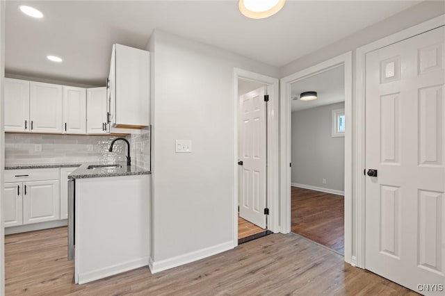 331 Darlington Rd, Syracuse, NY 13208 - kitchen with white cabinetry, light stone countertops, backsplash, light wood-style floors, and recessed lighting