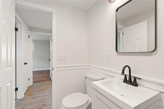 331 Darlington Rd, Syracuse, NY 13208 - half bathroom with wood finished floors, vanity, and a wainscoted wall