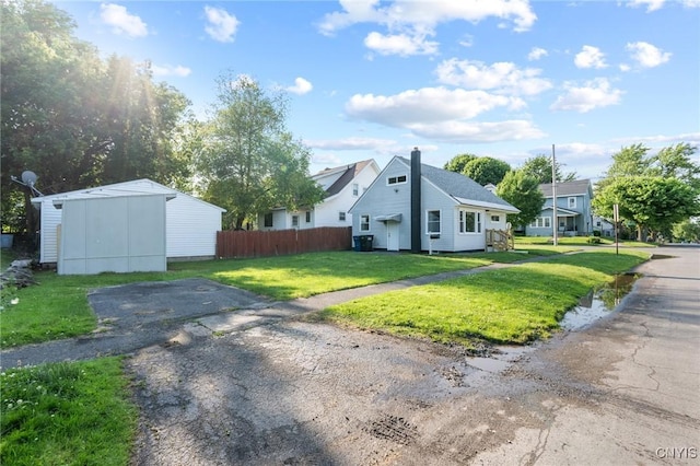331 Darlington Rd, Syracuse, NY 13208 - view of side of property featuring an outdoor structure and a chimney