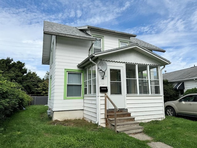 207 Morrow St, Elmira-City, NY 14904 - view of front facade featuring a sunroom, entry steps, and roof with shingles