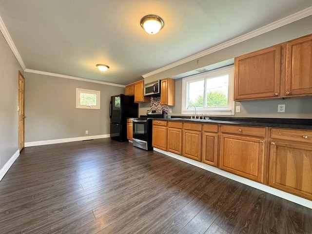 207 Morrow St, Elmira-City, NY 14904 - kitchen with stainless steel appliances, dark countertops, ornamental molding, dark wood finished floors, and plenty of natural light