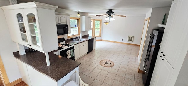 527 Harper Rd, Harpersfield, NY 13786 - kitchen featuring black appliances, dark countertops, a ceiling fan, and glass insert cabinets