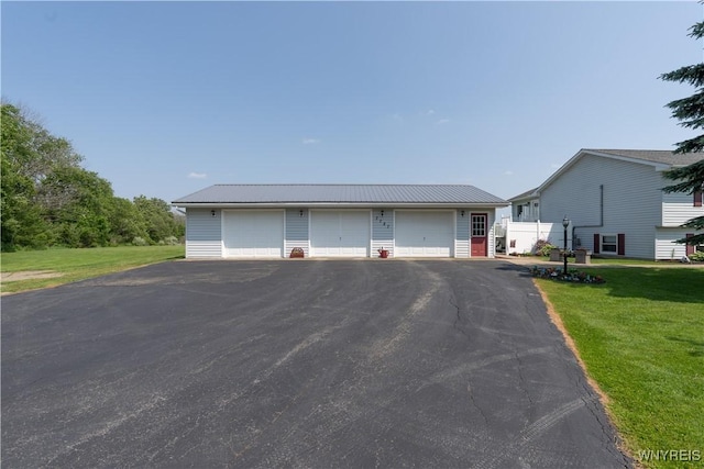 7727 Dewitt Rd, Pike, NY 14024 - view of front of home featuring a garage, a front yard, an outbuilding, and a metal roof