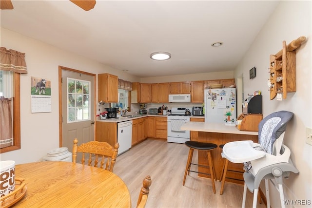 7727 Dewitt Rd, Pike, NY 14024 - kitchen with white appliances, light wood-style flooring, a peninsula, light countertops, and recessed lighting