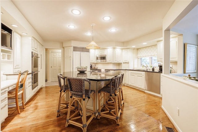 7974 Oak Brook Cir, Pittsford, NY 14534 - dining space with recessed lighting and light wood finished floors