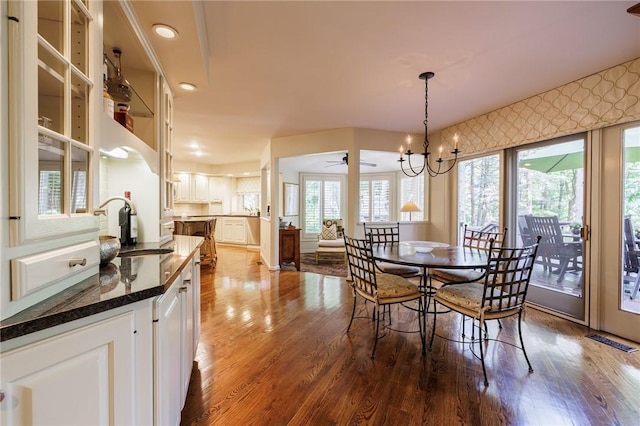 7974 Oak Brook Cir, Pittsford, NY 14534 - dining room featuring healthy amount of natural light, a chandelier, and wood finished floors