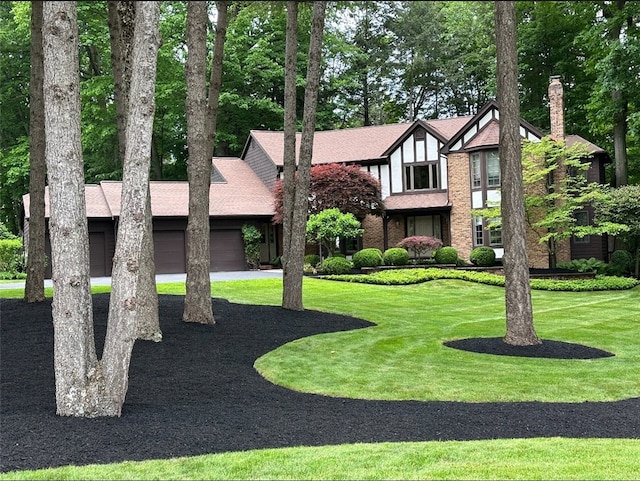 7974 Oak Brook Cir, Pittsford, NY 14534 - view of front of property with a garage, a front lawn, driveway, and a chimney