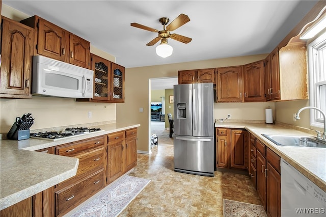 774 Loretta St, Tonawanda-Town, NY 14150 - kitchen featuring white appliances, a ceiling fan, light countertops, and brown cabinetry