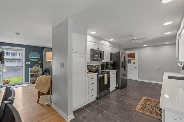 125 Huntshill Rd, Geddes, NY 13209 - kitchen with stainless steel appliances, light countertops, white cabinetry, backsplash, and a ceiling fan