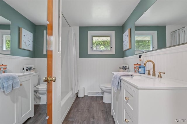 125 Huntshill Rd, Geddes, NY 13209 - full bathroom featuring wainscoting, vanity, wood finished floors, and shower / tub combo