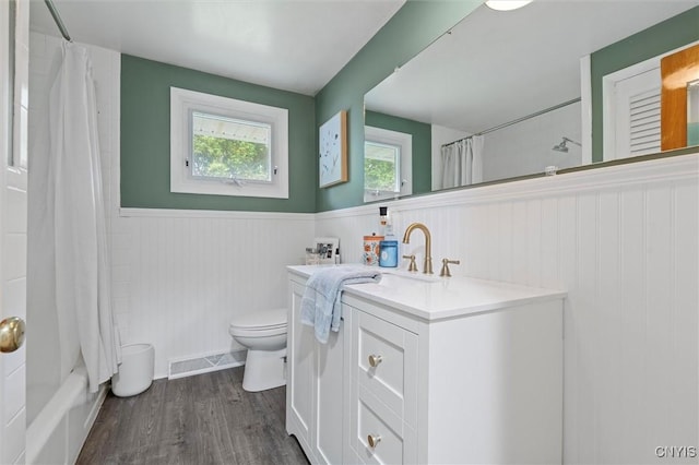 125 Huntshill Rd, Geddes, NY 13209 - bathroom featuring wainscoting, vanity, wood finished floors, and shower / bath combination with curtain