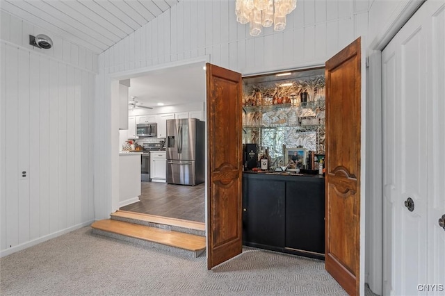 125 Huntshill Rd, Geddes, NY 13209 - bar with stainless steel appliances, carpet floors, a chandelier, vaulted ceiling, and a ceiling fan