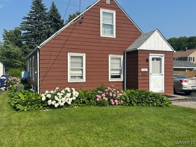 715 83rd St, Niagara Falls, NY 14304 - view of front of house featuring a front yard and board and batten siding