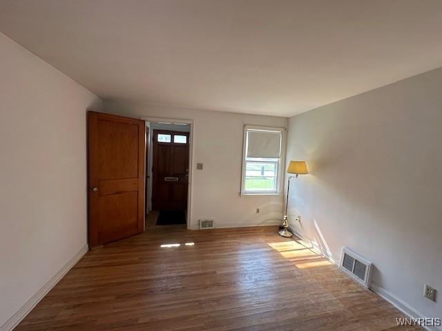 715 83rd St, Niagara Falls, NY 14304 - empty room with dark wood finished floors and baseboards