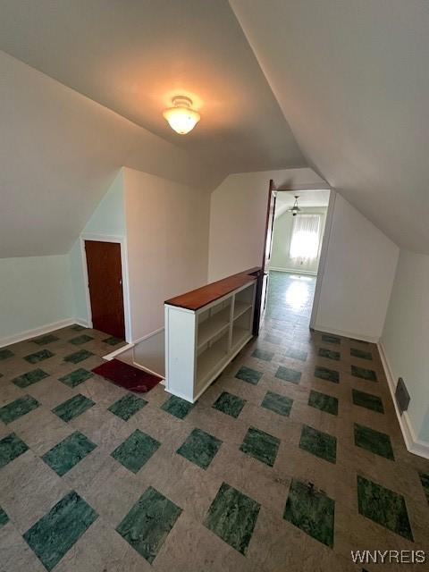 715 83rd St, Niagara Falls, NY 14304 - additional living space featuring vaulted ceiling and baseboards