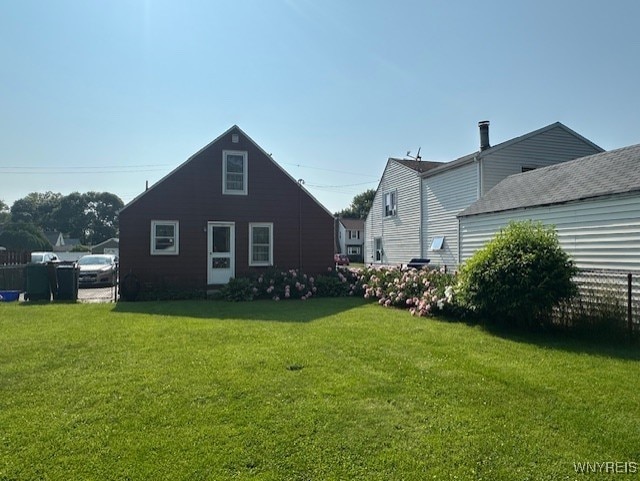 715 83rd St, Niagara Falls, NY 14304 - back of house featuring a yard
