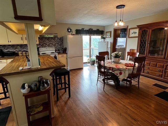 298 Maple Ridge Rd, Dekalb, NY 13681 - dining area featuring a textured ceiling and dark wood-type flooring
