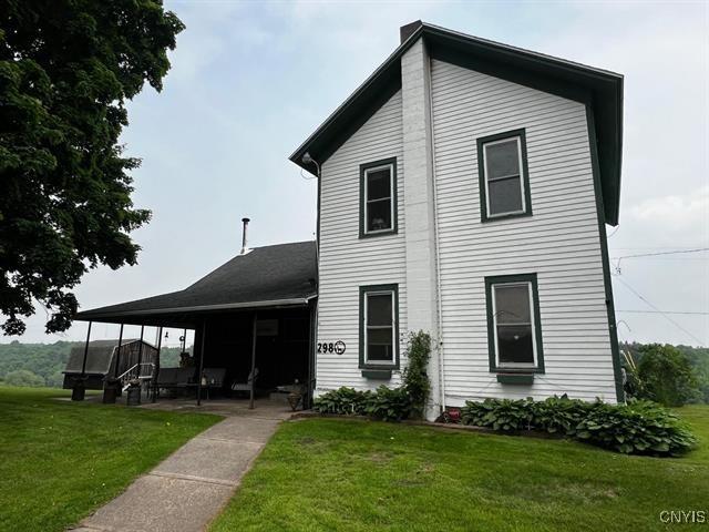298 Maple Ridge Rd, Dekalb, NY 13681 - rear view of property featuring a lawn and a patio area