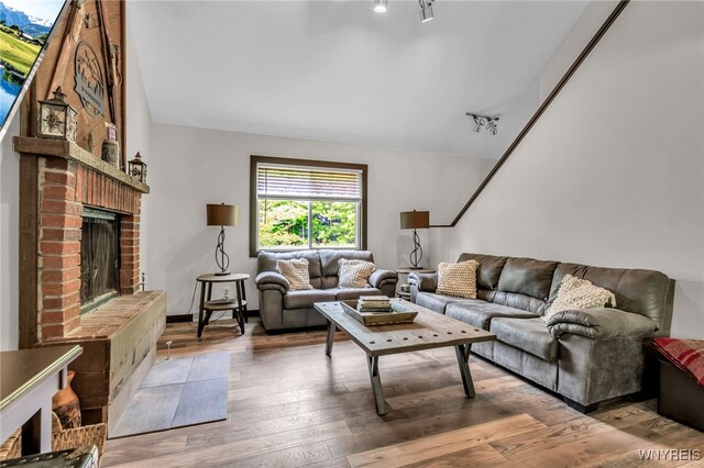 28 Woodstock Rd, Concord, NY 14069 - living area with a brick fireplace and light wood-style floors