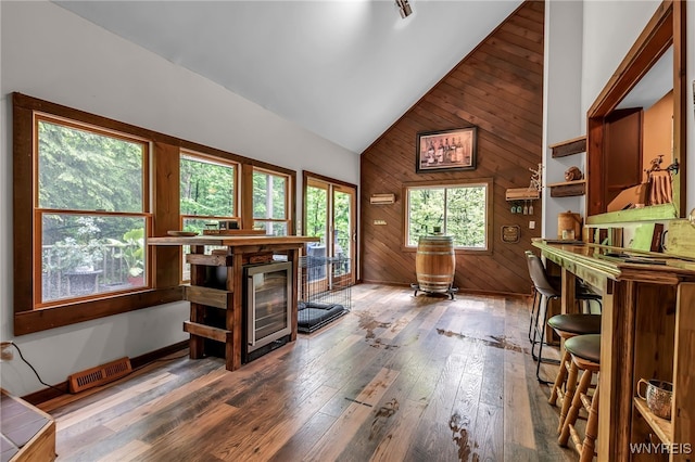 28 Woodstock Rd, Concord, NY 14069 - office area with wine cooler, wood walls, high vaulted ceiling, and hardwood / wood-style flooring
