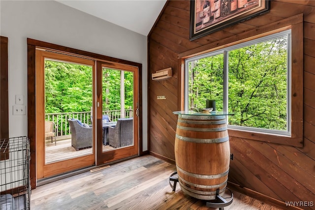 28 Woodstock Rd, Concord, NY 14069 - doorway to outside featuring vaulted ceiling, wood walls, and light wood finished floors