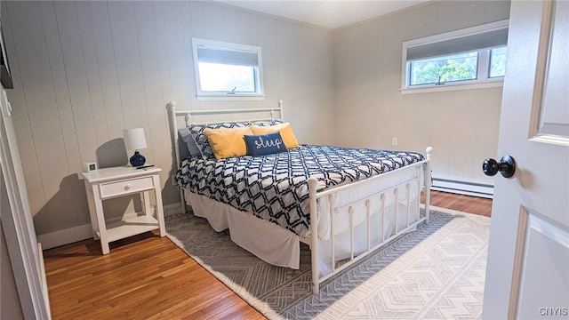 53 Utica St, Hamilton, NY 13346 - bedroom with wood finished floors and a baseboard heating unit