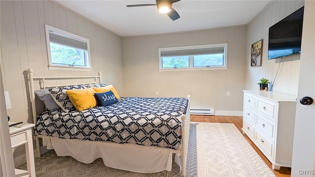 53 Utica St, Hamilton, NY 13346 - bedroom with a baseboard heating unit, multiple windows, light wood finished floors, and ceiling fan