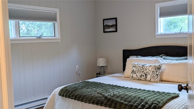 53 Utica St, Hamilton, NY 13346 - bedroom featuring a baseboard heating unit and multiple windows