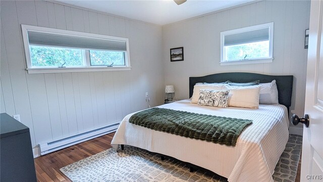 53 Utica St, Hamilton, NY 13346 - bedroom with a baseboard heating unit, wood finished floors, and multiple windows