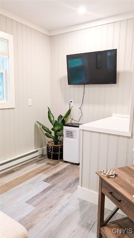 53 Utica St, Hamilton, NY 13346 - living room with light wood-style floors and a baseboard heating unit